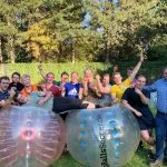 Groupe d'enterrement de vie de garçon jouant au football à bulles